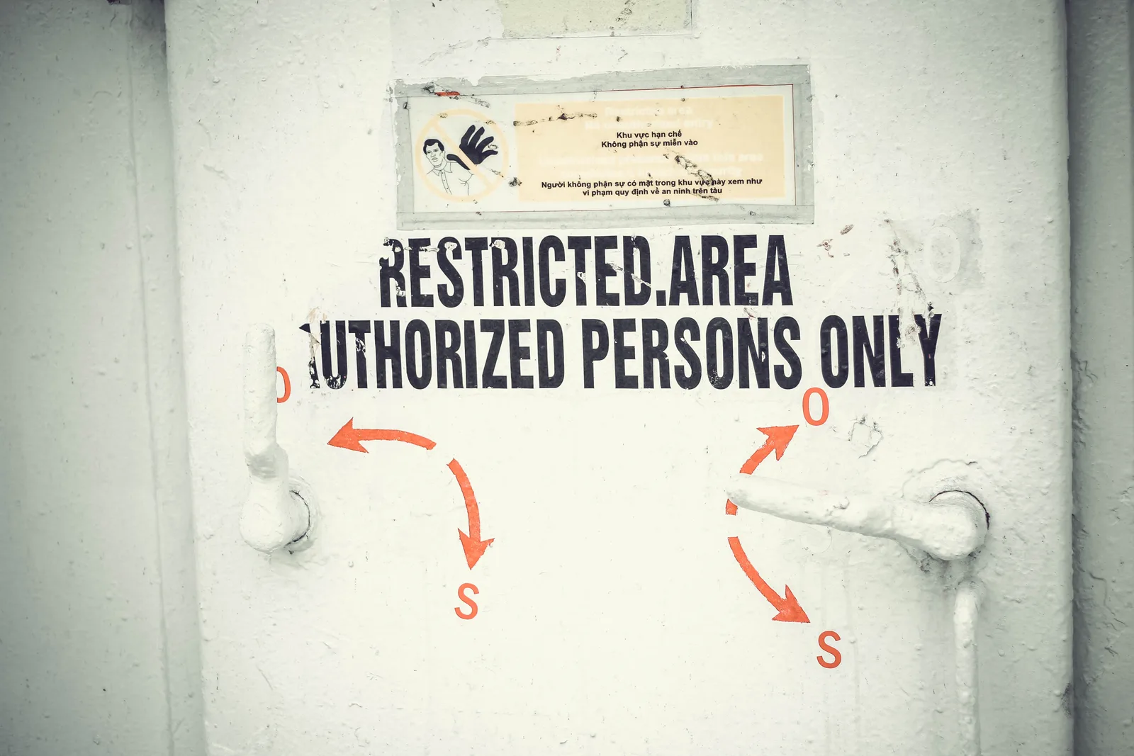 Close-up of a restricted area door with signage emphasizing authorized access only.